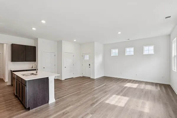 a view of room with wooden floor and flat screen tv