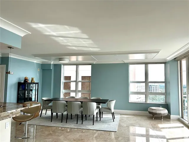 a view of a dining room with furniture and windows