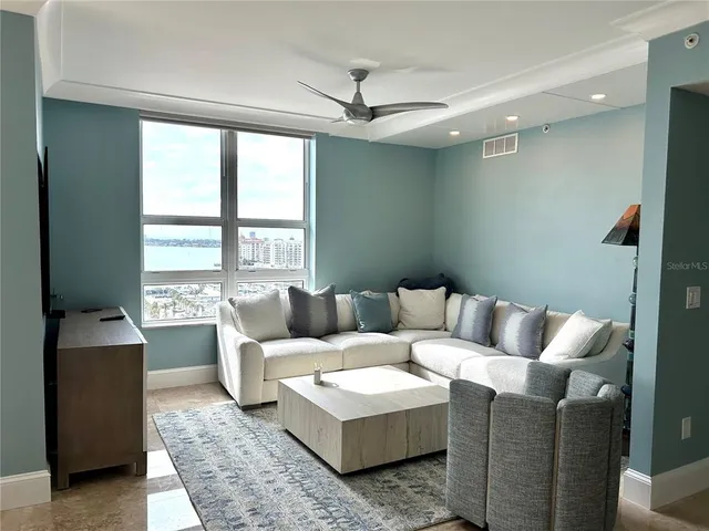 a living room with furniture and a large window