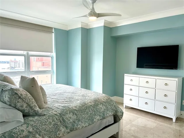 a bed sitting in a bedroom next to a window