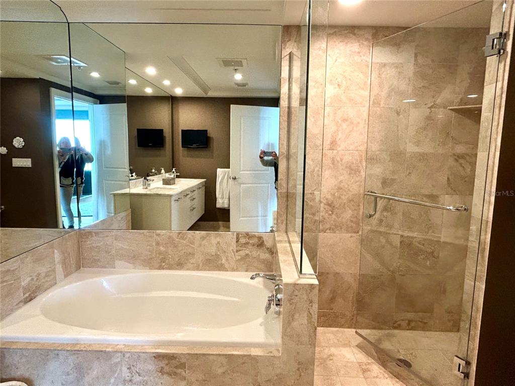 1350 Main Street, Unit 1210 Sarasota, FL 34236 - Photo 33 of 53 a large tub sitting in a hall with a large window