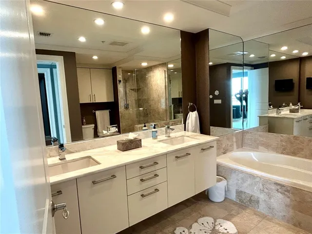 a view of a swimming pool with outdoor seating and plants