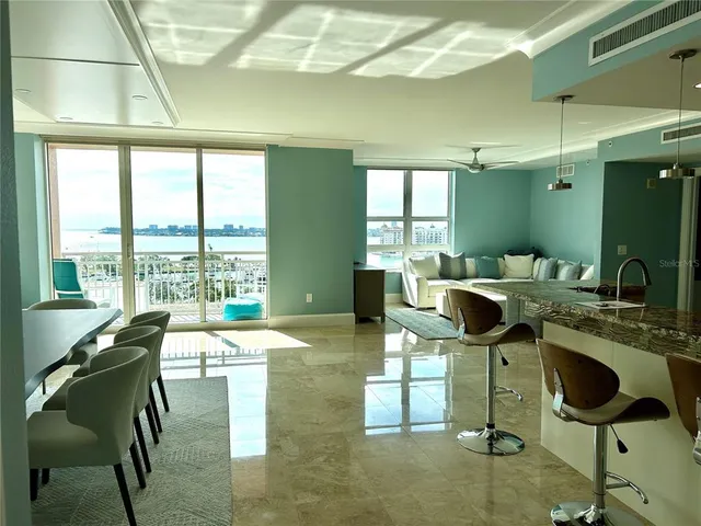 a view of a dining room with furniture a chandelier and wooden floor