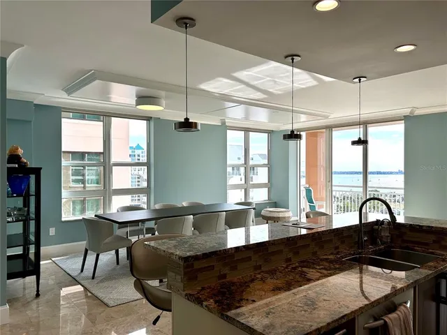 a kitchen with a table chairs and window