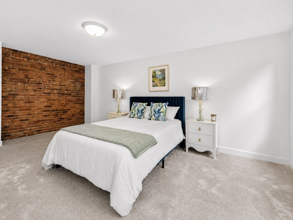 18 R Polk Street Boston, MA 02129 - Photo 13 of 19 a bedroom with a bed and a wall painting
