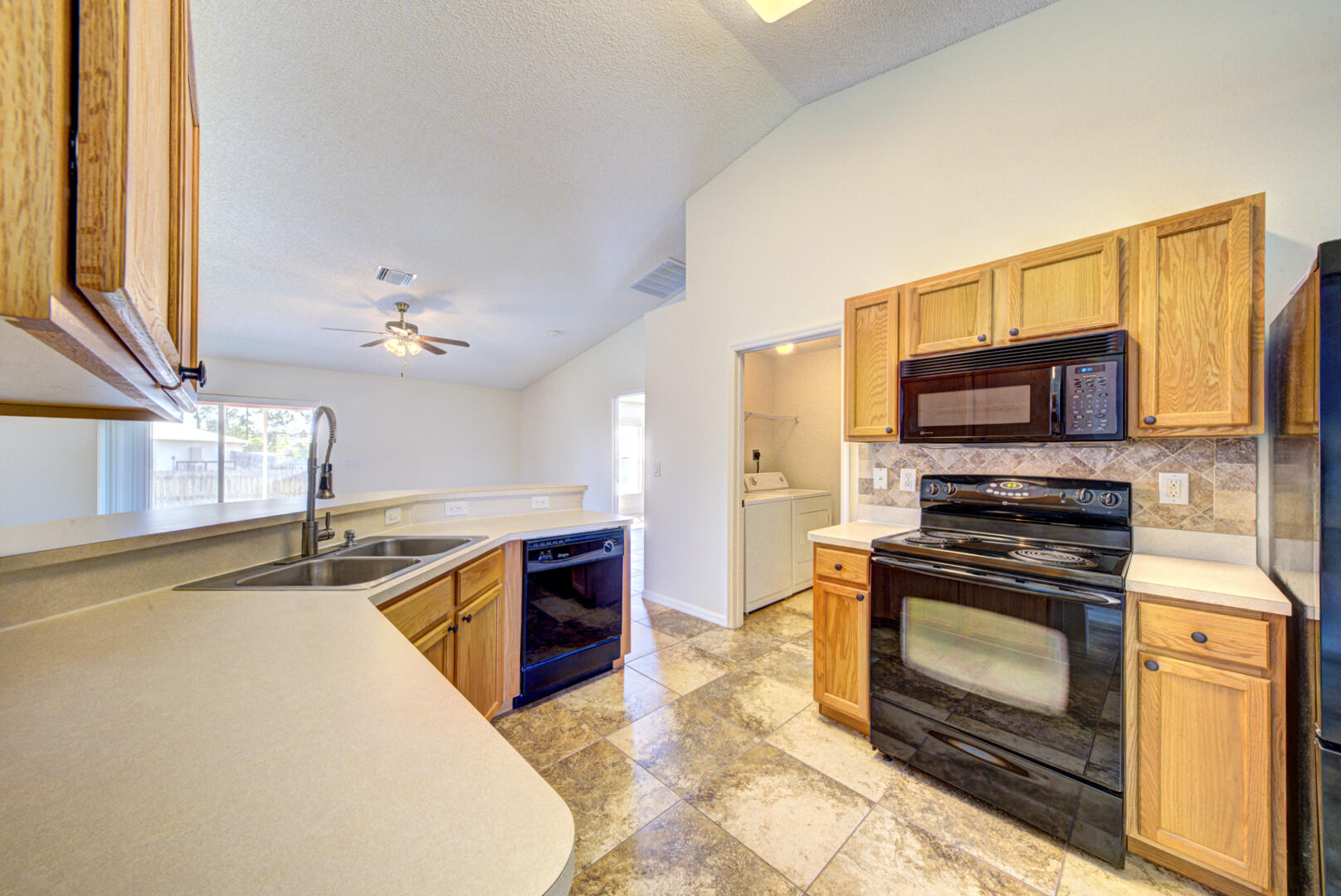 1453 Goyer Road Southeast Palm Bay, FL 32909 - Photo 16 of 41 kitchen with vaulted ceiling