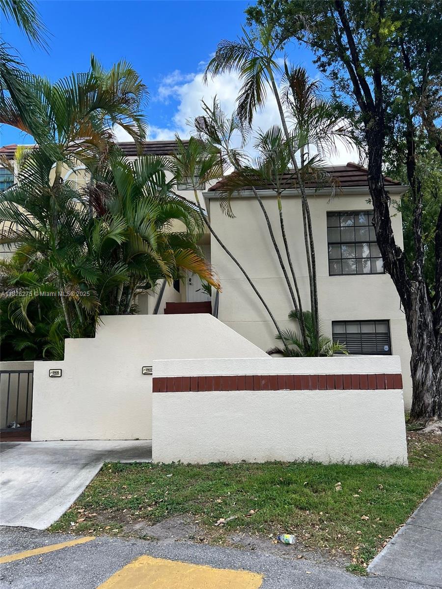 12922 Southwest 88th Terrace, Unit B206 Miami, FL 33186 - Photo 1 of 16 a view of a house with a yard