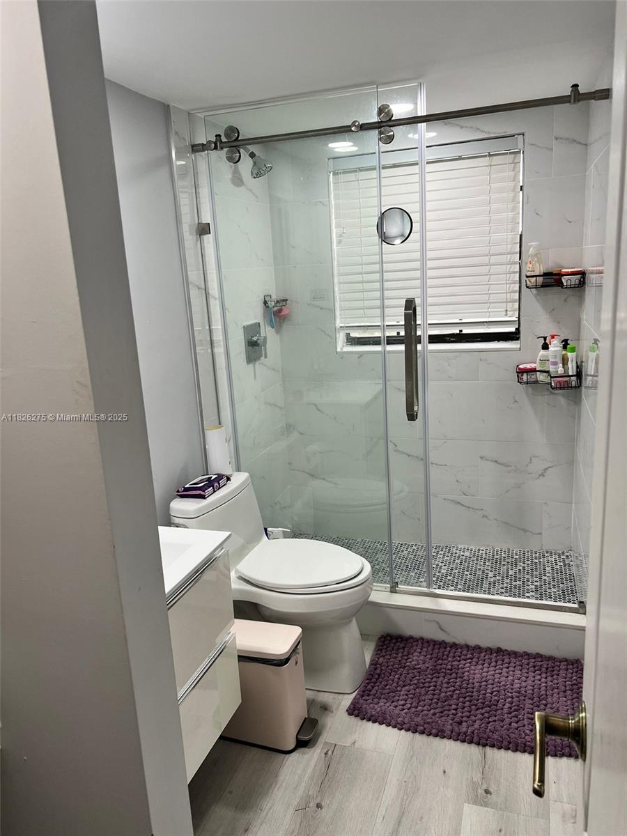 12922 Southwest 88th Terrace, Unit B206 Miami, FL 33186 - Photo 11 of 16 a bathroom with a toilet and a shower