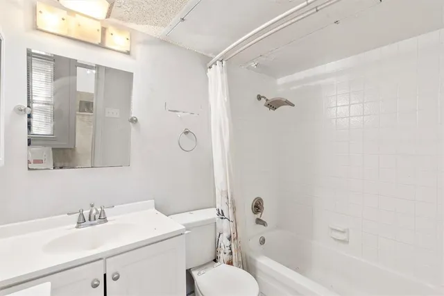 a bathroom with a sink toilet tub and shower
