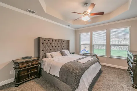 a bed room with a bed and a large window