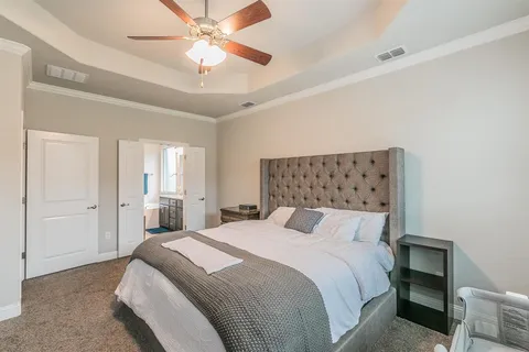a bedroom with a bed and a chandelier