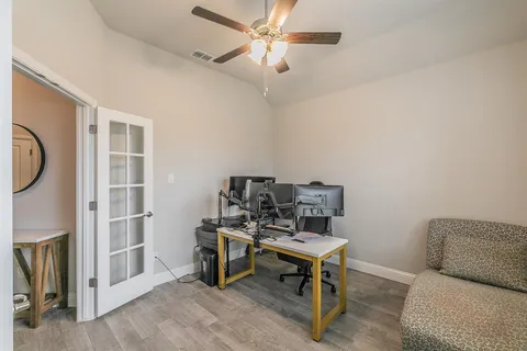 a reading room with furniture and wooden floor