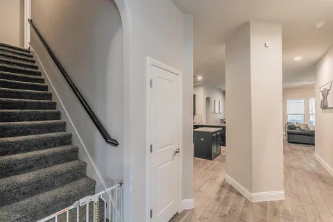 a view of entryway and hall with wooden floor