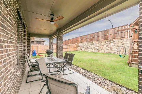 a view of a porch with furniture and garden