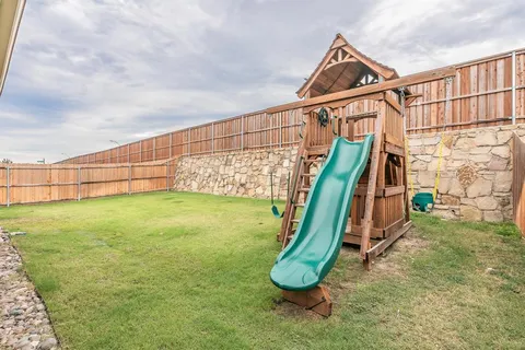 a view of a house with a swimming pool and a yard