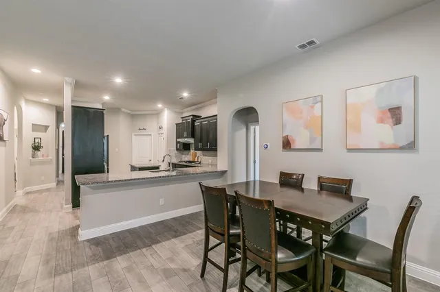 a dining area with furniture and a view of kitchen
