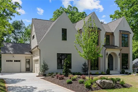 a living room with furniture fireplace and a large window