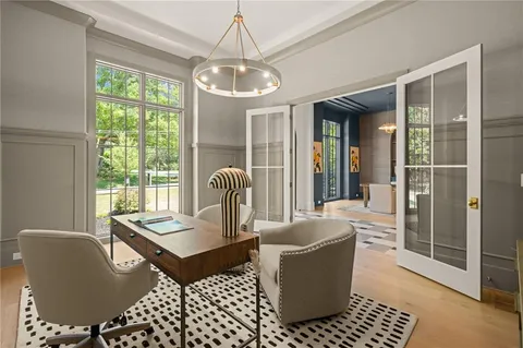 a dining room with furniture and wooden floor