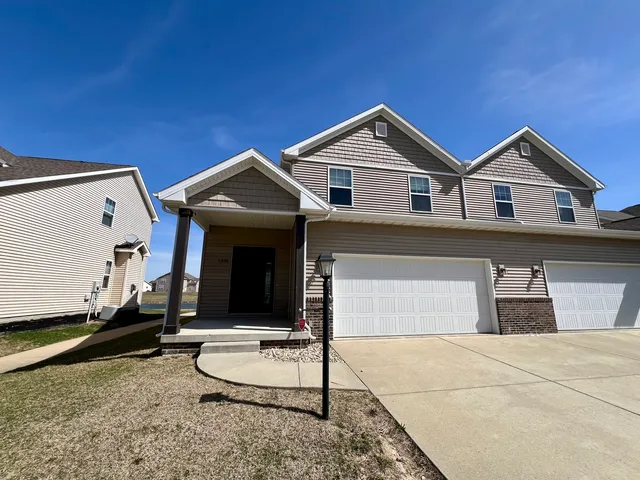 a front view of a house with a garage