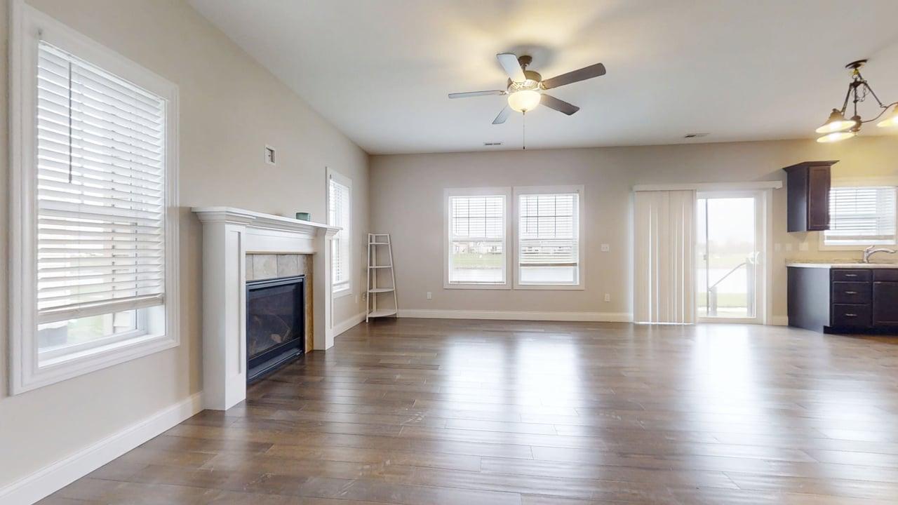 1320 Myrtle Beach Avenue Champaign, IL 61822 - Photo 2 of 29 an empty room with wooden floor fireplace and windows