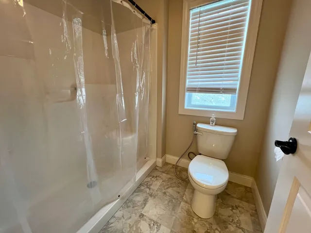 a spacious bathroom with a double vanity sink a large mirror and a shower