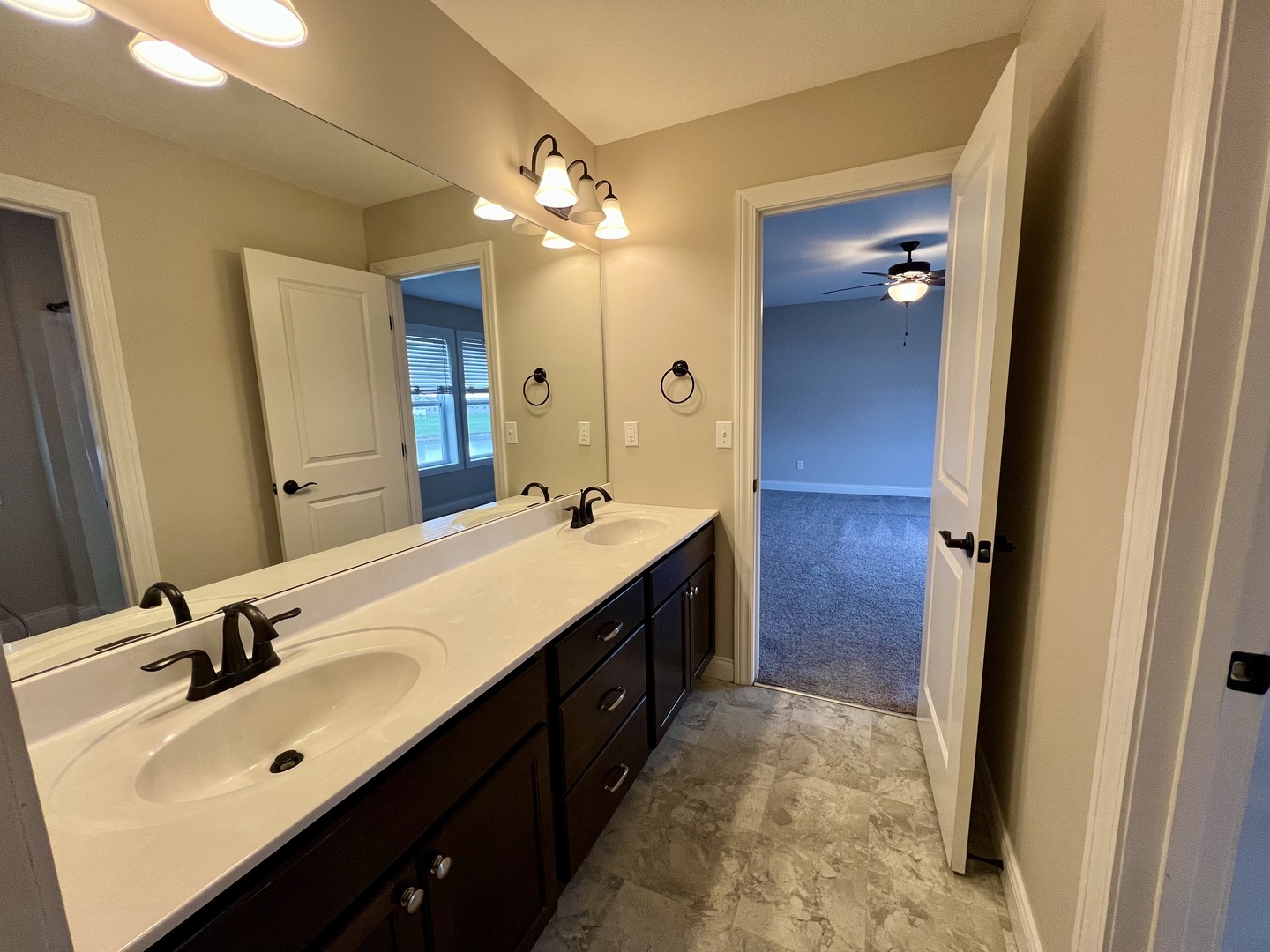 1320 Myrtle Beach Avenue Champaign, IL 61822 - Photo 26 of 29 a spacious bathroom with a double vanity sink a large mirror and a shower