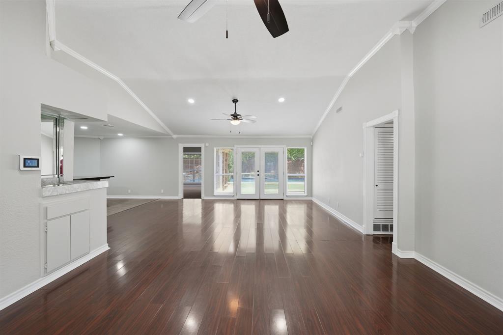 1108 Billie Ruth Lane Hurst, TX 76053 - Photo 8 of 27 Expansive interior featuring high ceilings, wood-finish flooring, and white crown molding
