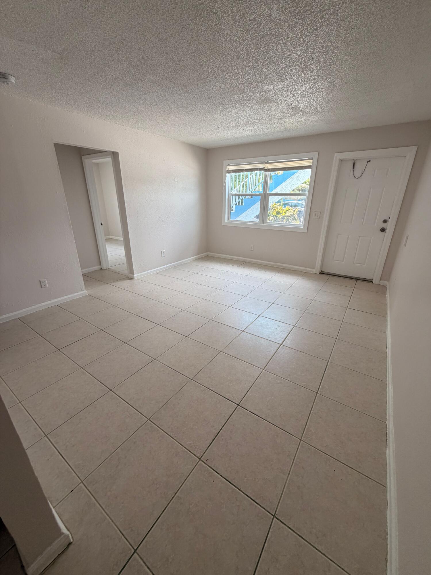 1618 West 26th Court, Unit A Riviera Beach, FL 33404 - Photo 2 of 15 a view of an empty room and a window