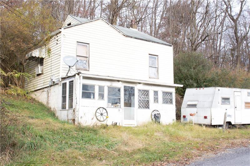 695 Shaffer Road Hookstown, PA 15050 - Photo 20 of 26 a view of a white house with large windows and a tree