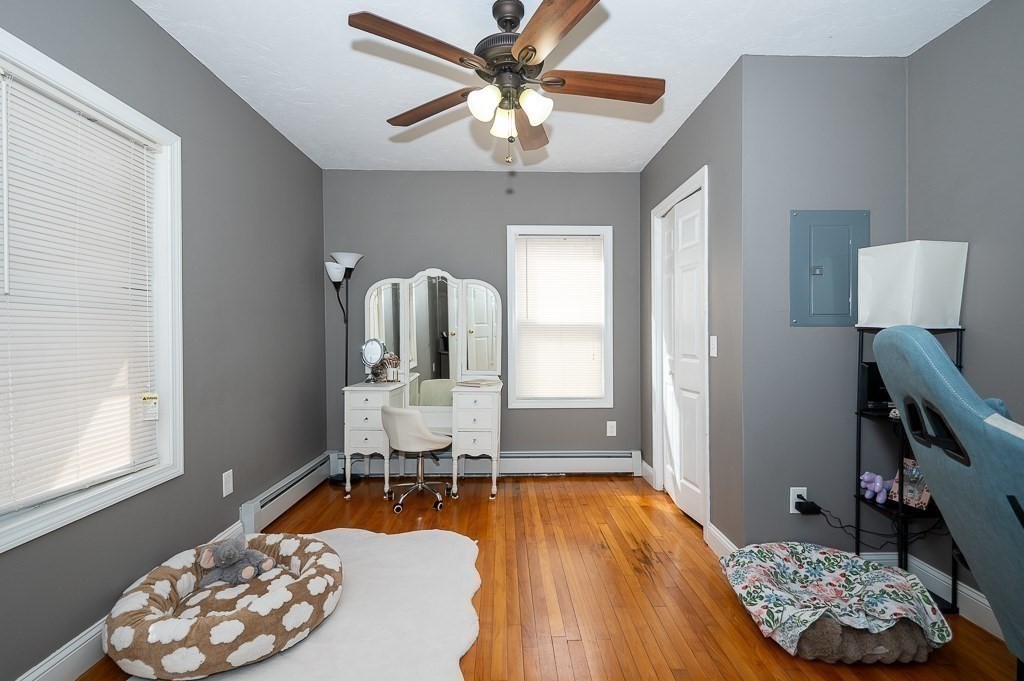 134 Baker Street Gardner, MA 01440 - Photo 22 of 42 a bedroom with a bed and a chandelier