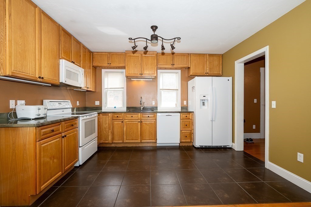 134 Baker Street Gardner, MA 01440 - Photo 3 of 42 a kitchen with refrigerator and cabinets