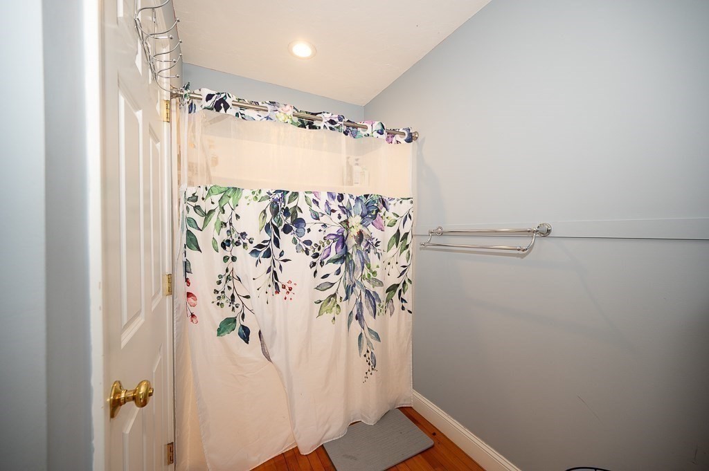 134 Baker Street Gardner, MA 01440 - Photo 32 of 42 a bathroom with a shower curtain and a curtain