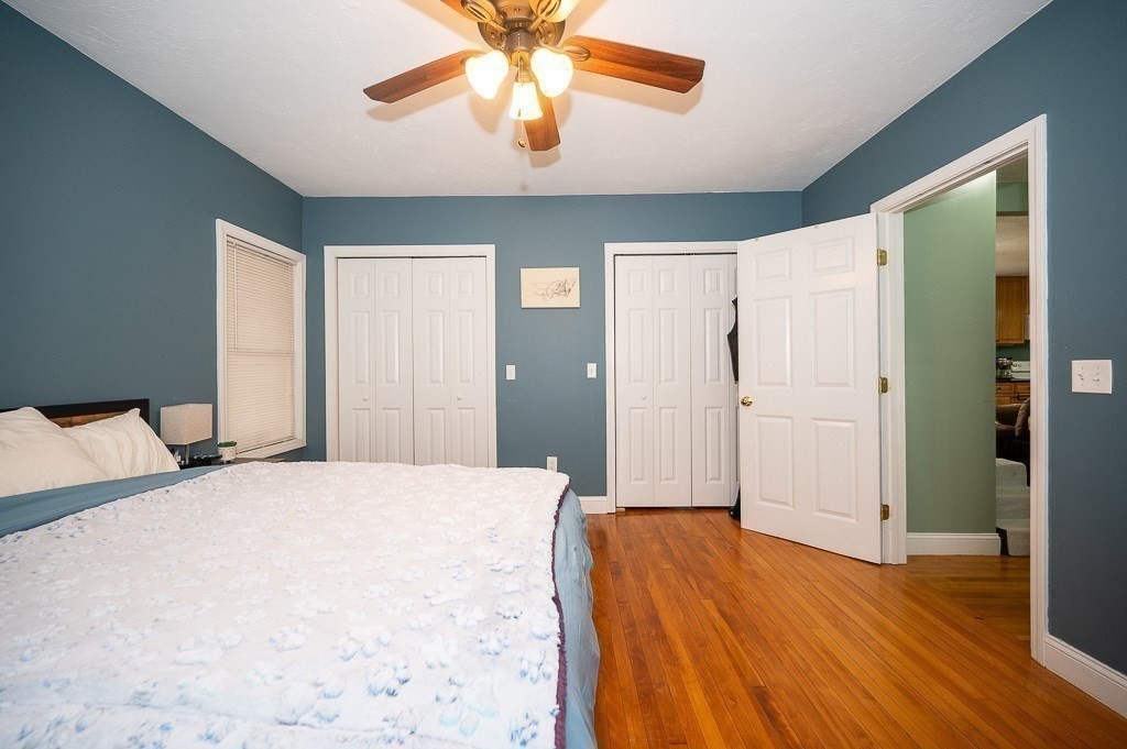 134 Baker Street Gardner, MA 01440 - Photo 34 of 42 a bedroom with a bed and a chandelier
