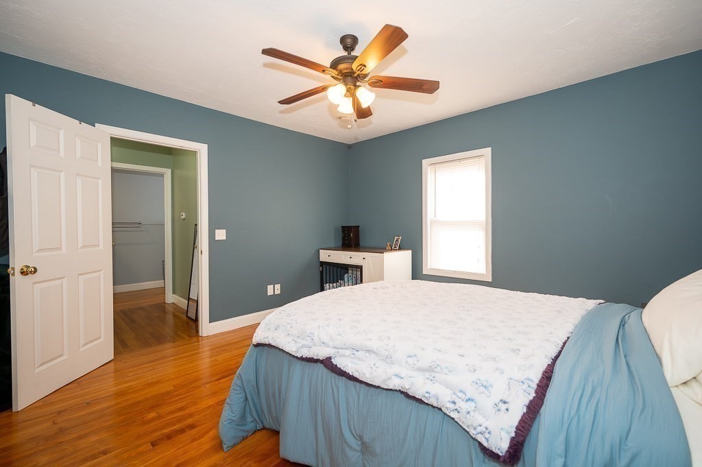134 Baker Street Gardner, MA 01440 - Photo 36 of 42 a bedroom with a bed and a chandelier