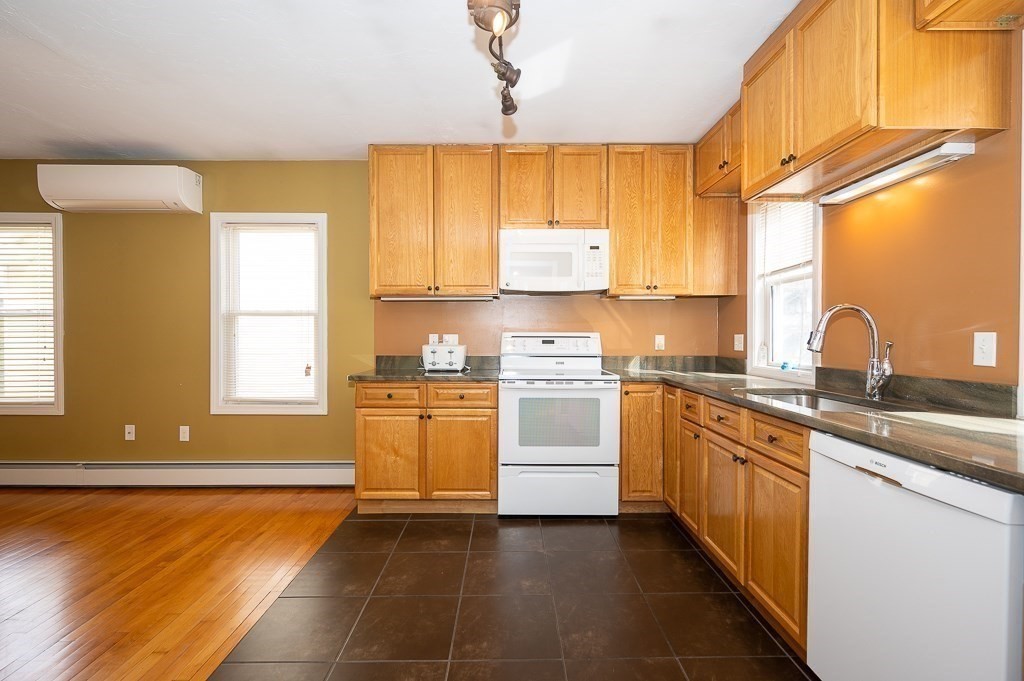 134 Baker Street Gardner, MA 01440 - Photo 4 of 42 a kitchen with stainless steel appliances granite countertop a sink and a stove