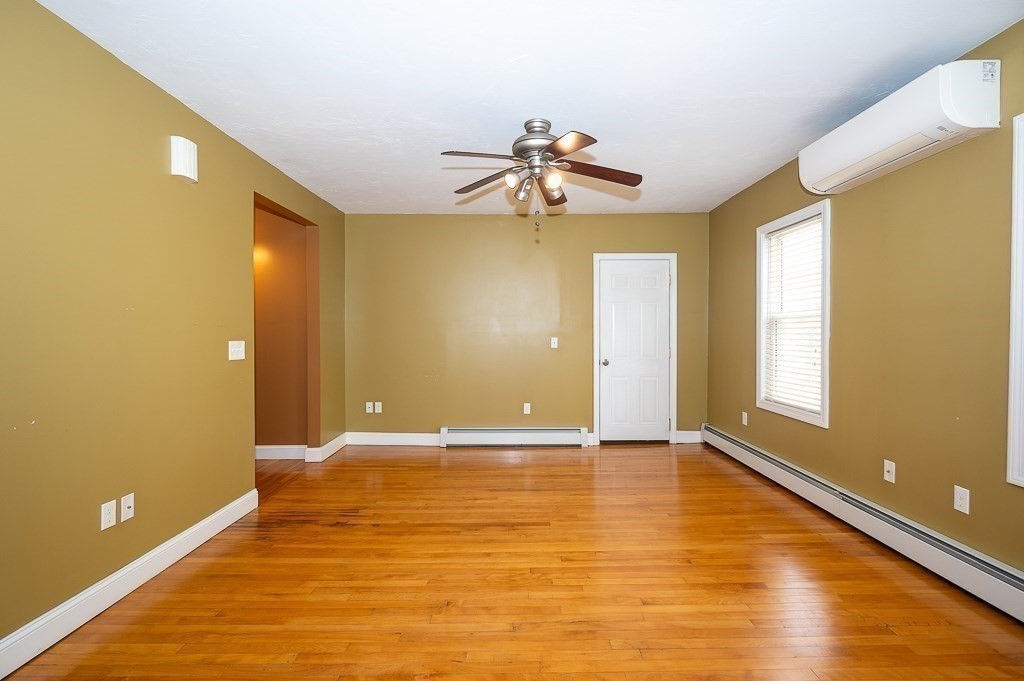 134 Baker Street Gardner, MA 01440 - Photo 6 of 42 a view of an empty room with window and wooden floor