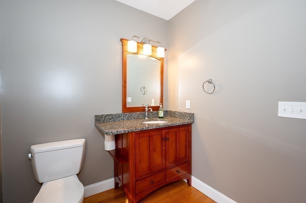 134 Baker Street Gardner, MA 01440 - Photo 7 of 42 a bathroom with a granite countertop toilet sink and mirror