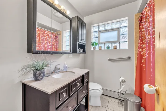 a bathroom with a sink a mirror and a toilet