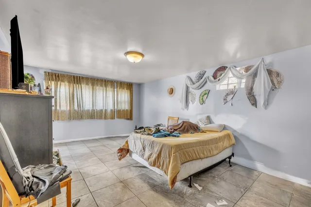 a bedroom with a bed and flat screen tv