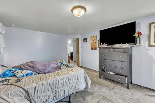 a bedroom with a bed and flat screen tv