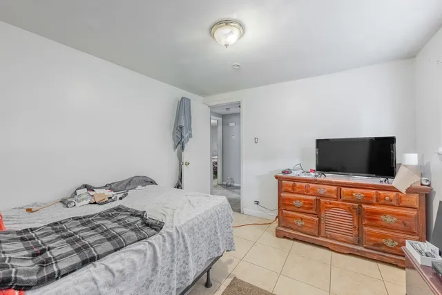 a bedroom with a bed and flat screen tv