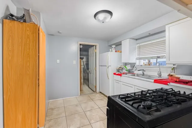 a kitchen with stainless steel appliances granite countertop a stove and a refrigerator