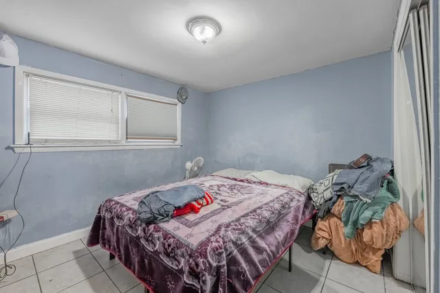 a bedroom with a bed and a window