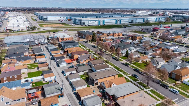 an aerial view of a house with a swimming pool yard and outdoor seating