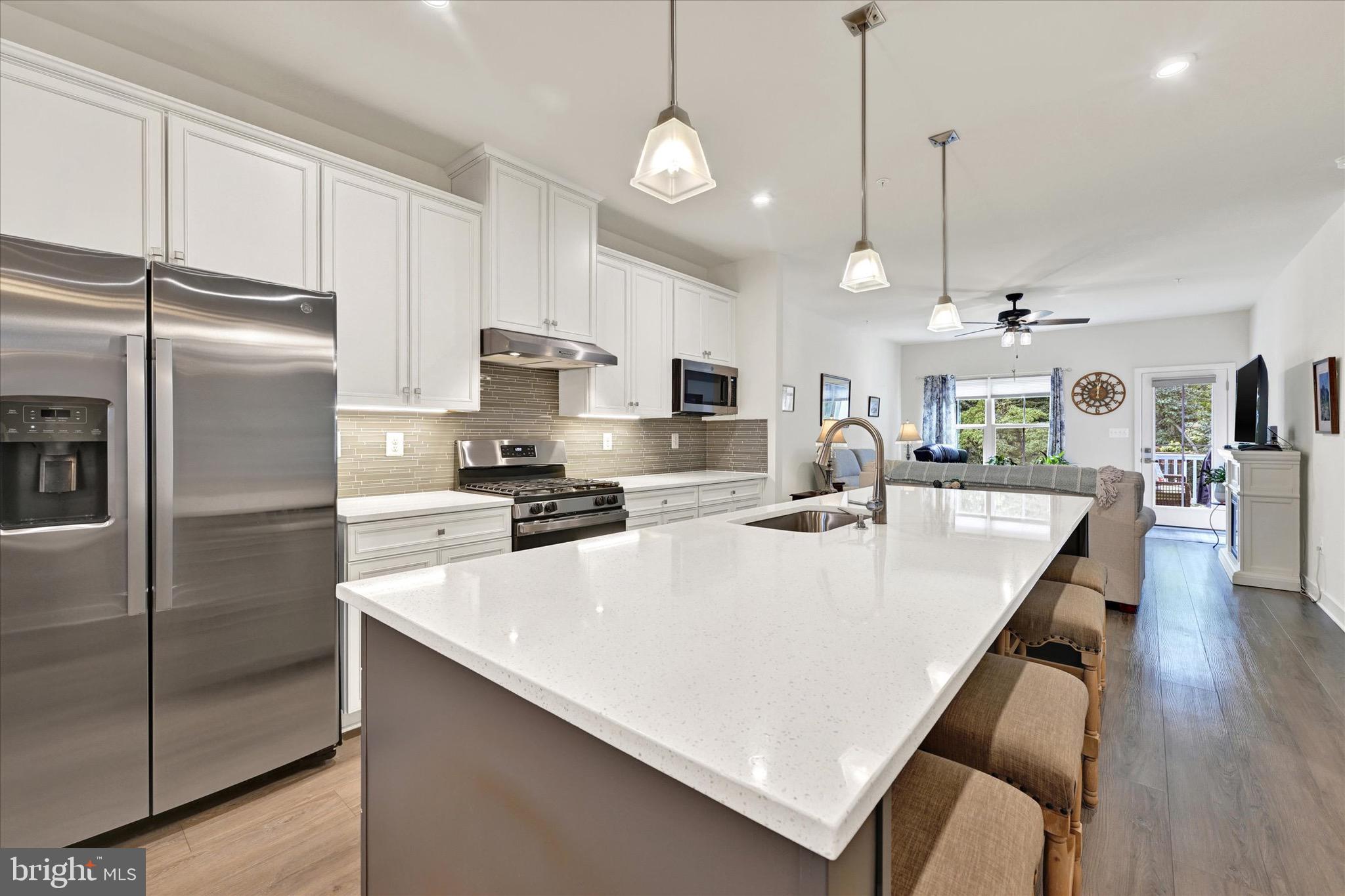 933 Swilken Bridge Road Aberdeen, MD 21001 - Photo 11 of 37 a large kitchen with kitchen island a stove a sink a refrigerator a center island a table and chairs