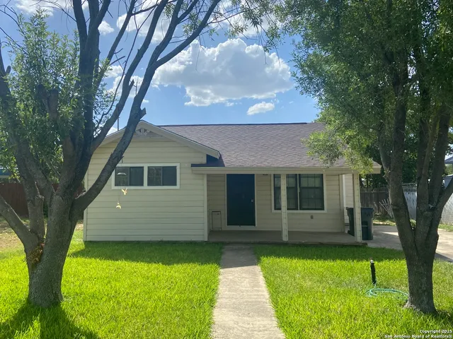 a front view of a house with a garden and yard