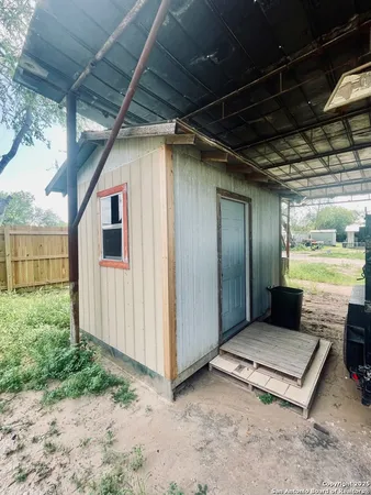 a view of a porch with wooden floor and fence