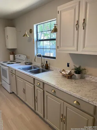 a kitchen with sink cabinets and window