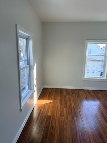 2 West 10th Street, Unit 2 Lowell, MA 01850 - Photo 13 of 13 wooden floor in an empty room with a window