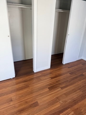 2 West 10th Street, Unit 2 Lowell, MA 01850 - Photo 4 of 13 an empty room with wooden floor and white wall